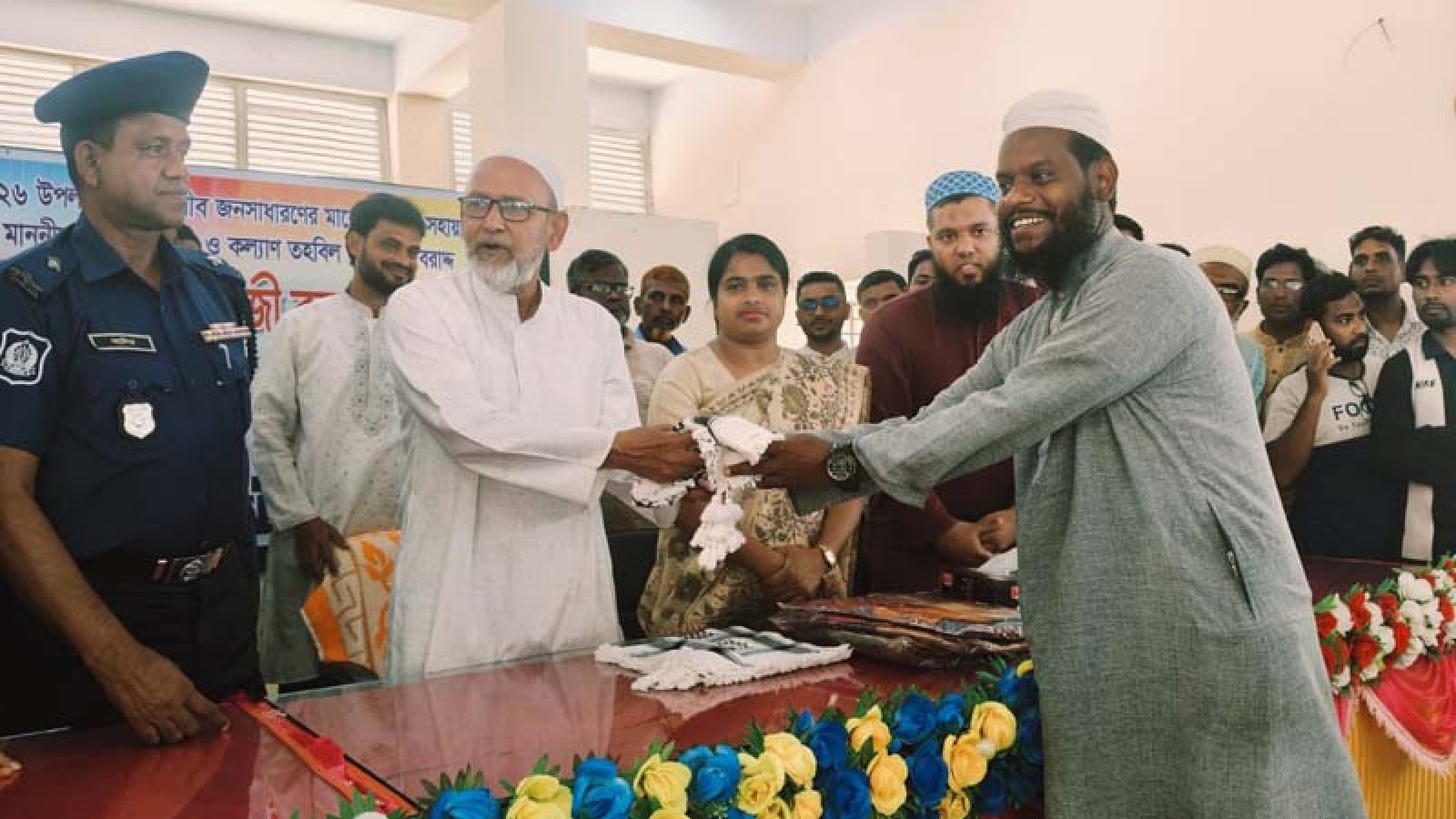 সাপাহারে প্রধানমন্ত্রীর ত্রাণ তহবিলের নগদ অর্থ শাড়ি থ্রি-পিস ও হাজী রুমাল বিতরণ