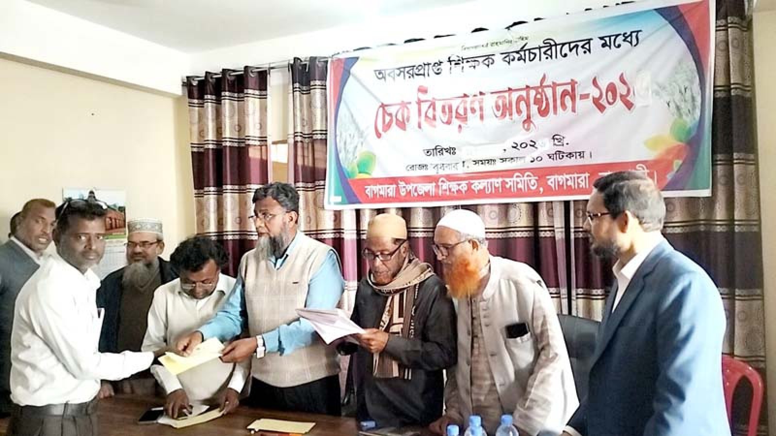 বাগমারায় ২৪জন শিক্ষক-কর্মচারীর মাঝে চেক বিতরণ